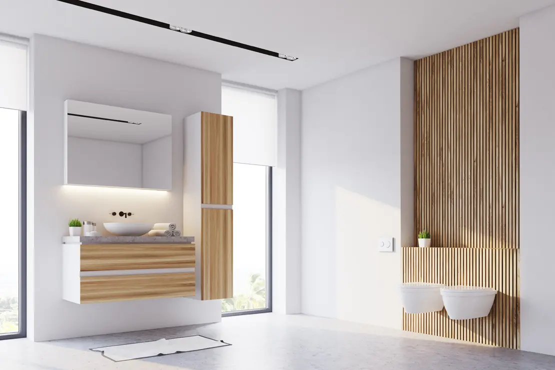 Cuarto de baño con piso de microcemento gris y componentes de madera.